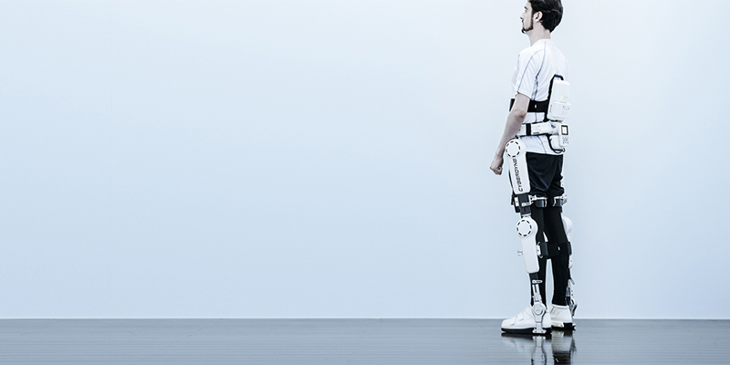 A person wearing the HAL lower limb exoskeleton on their lower limbs.